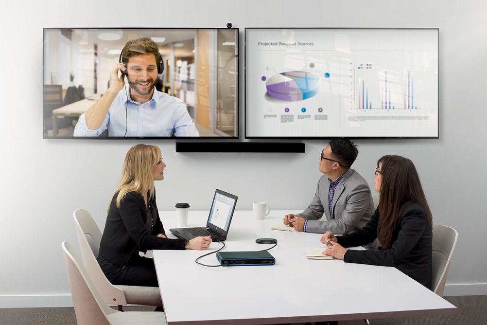 Biamp - Conferencing system in use by a team / a hybrid in-office-remote conference in session.